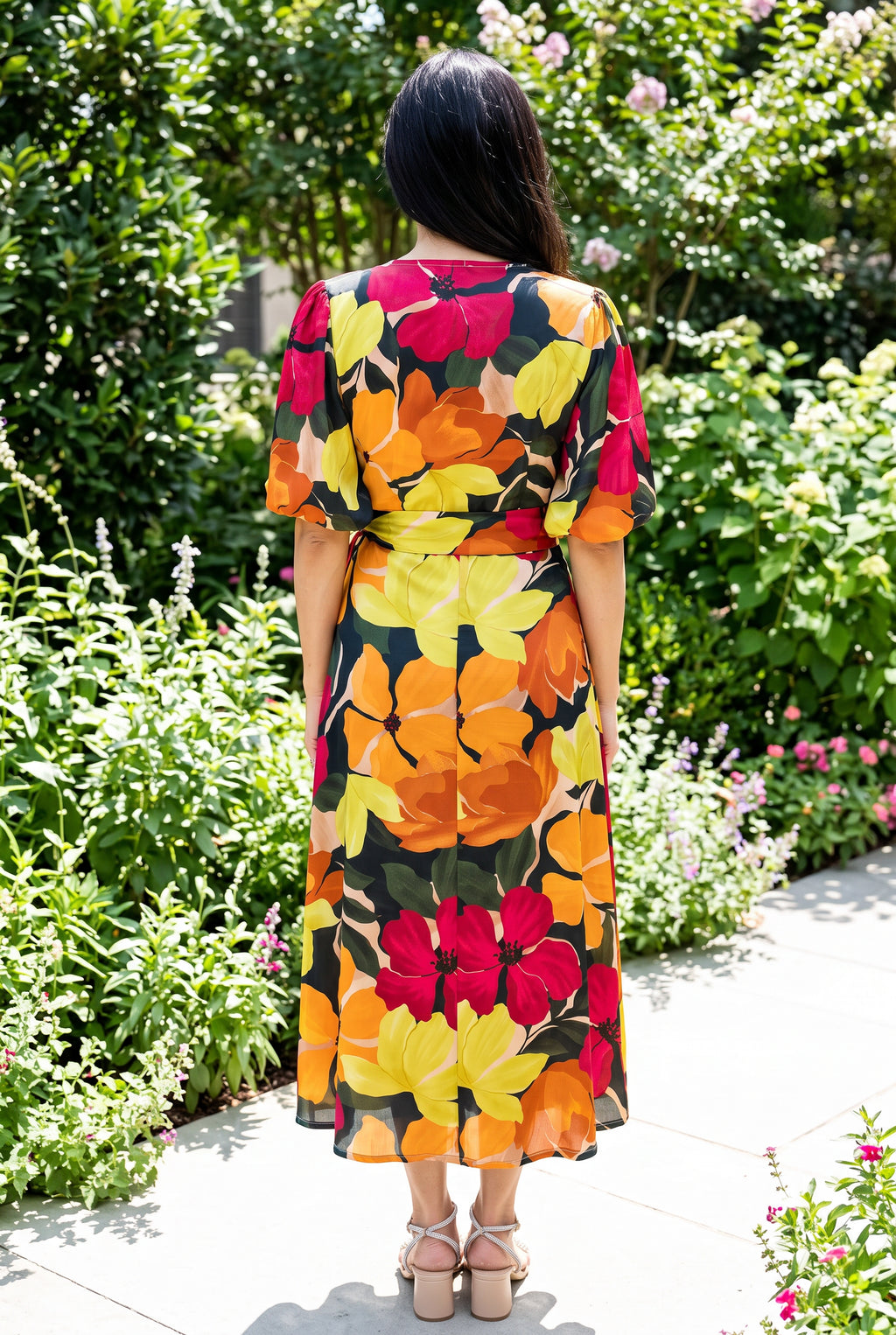 Back view of the floral wrap midi dress showing the high back, waist tie and A-line skirt.