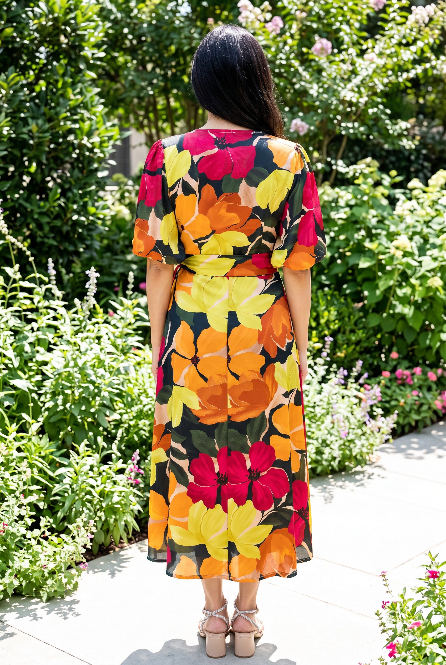Back view of the floral wrap midi dress showing the high back, waist tie and A-line skirt.