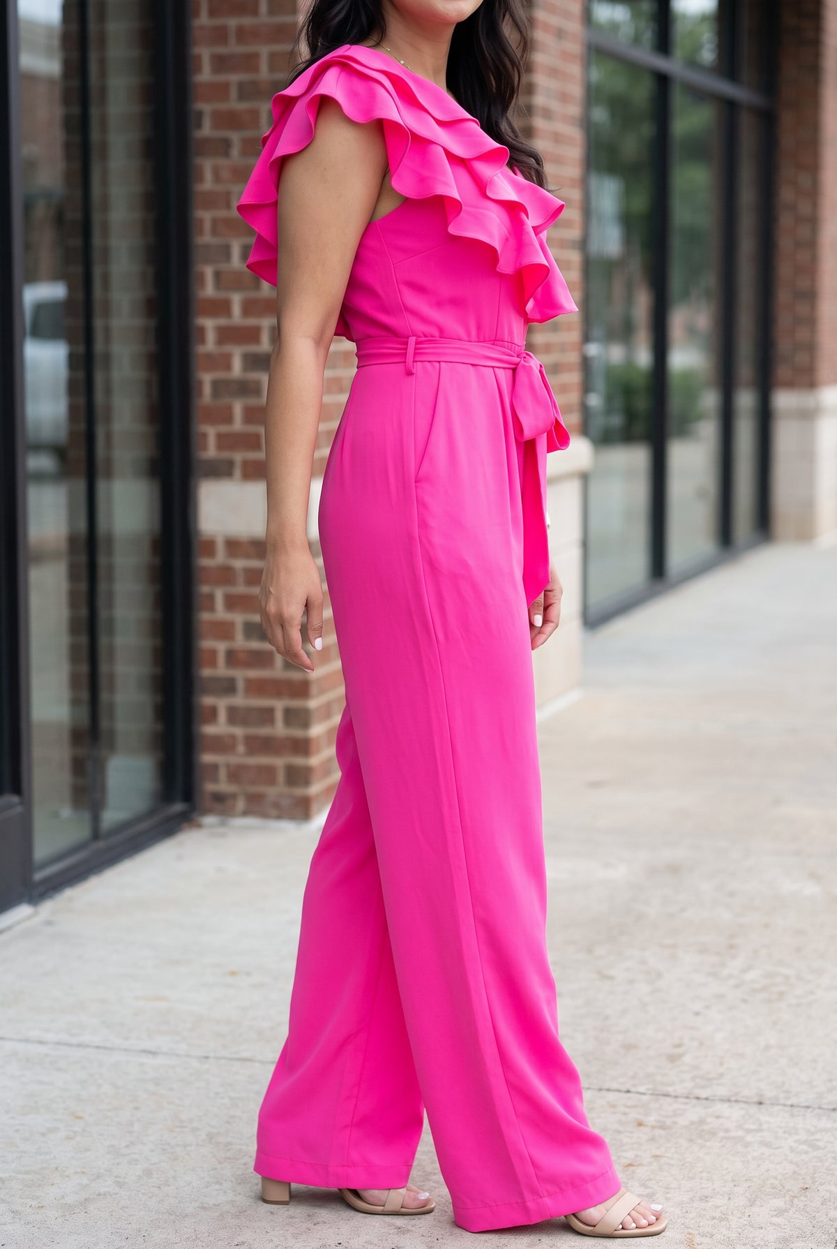 Angled side view of the Made You Look jumpsuit showing the armhole, waist, rise and wide-leg fall.
