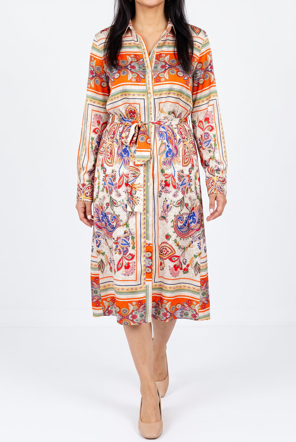 Scarf-print shirt dress worn in a bright studio, showing its walking drape and button-front opening.