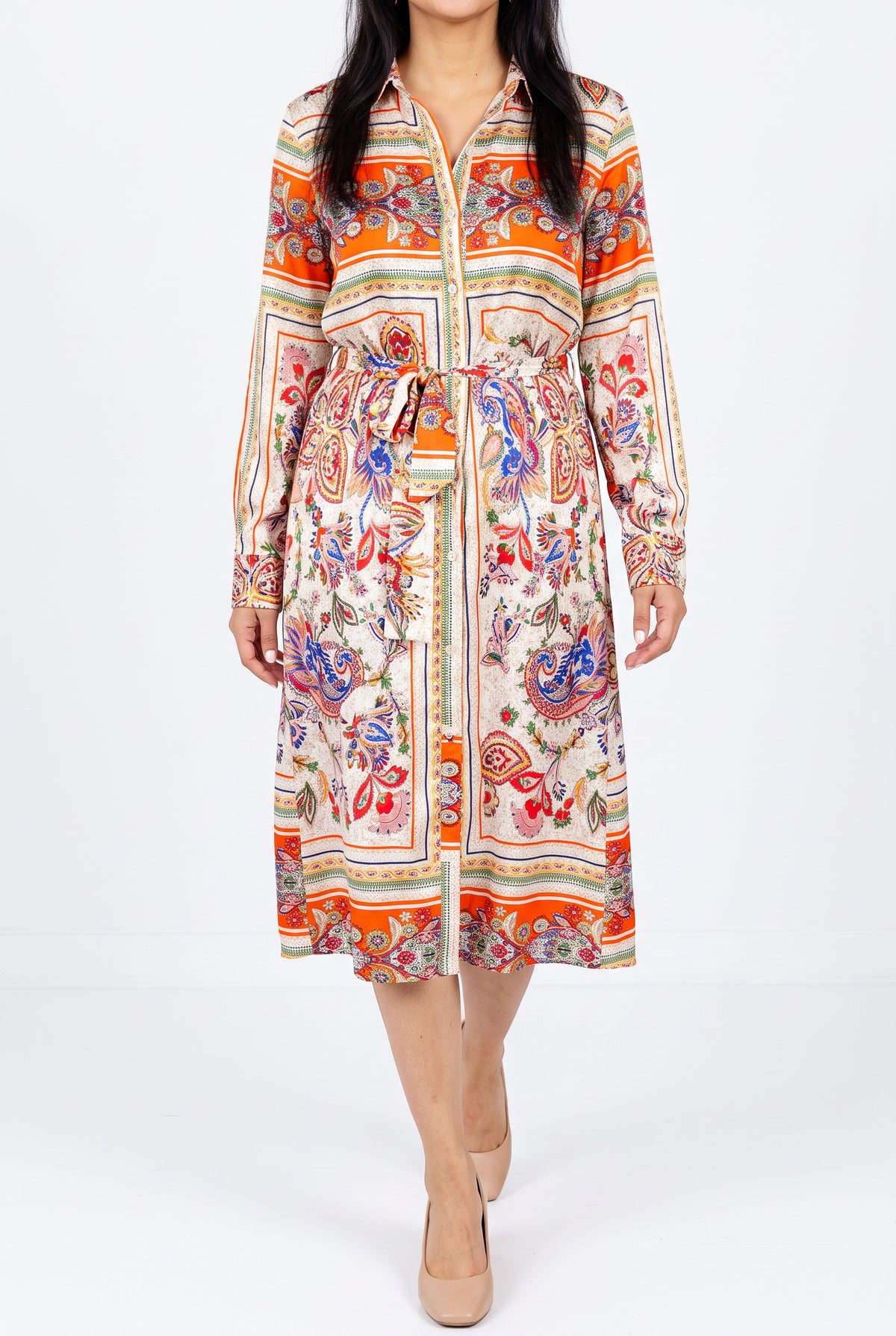Scarf-print shirt dress worn in a bright studio, showing its walking drape and button-front opening.