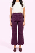 Front fit of Rollin' With You purple corduroy pants showing the high rise, pockets, and cropped wide legs.