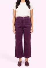 Front fit of Rollin' With You purple corduroy pants showing the high rise, pockets, and cropped wide legs.