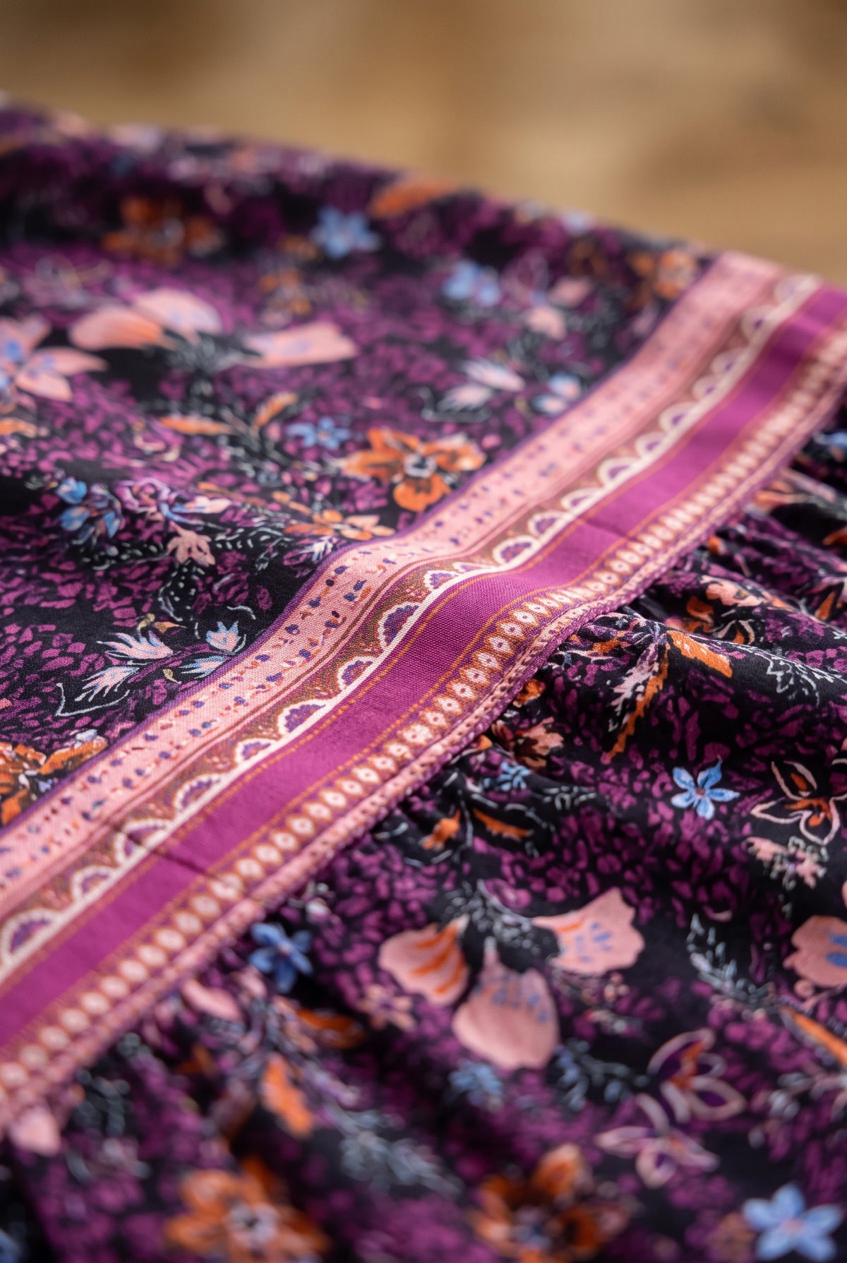 Floral field and geometric border detail on the Live in the Moment polyester dress.