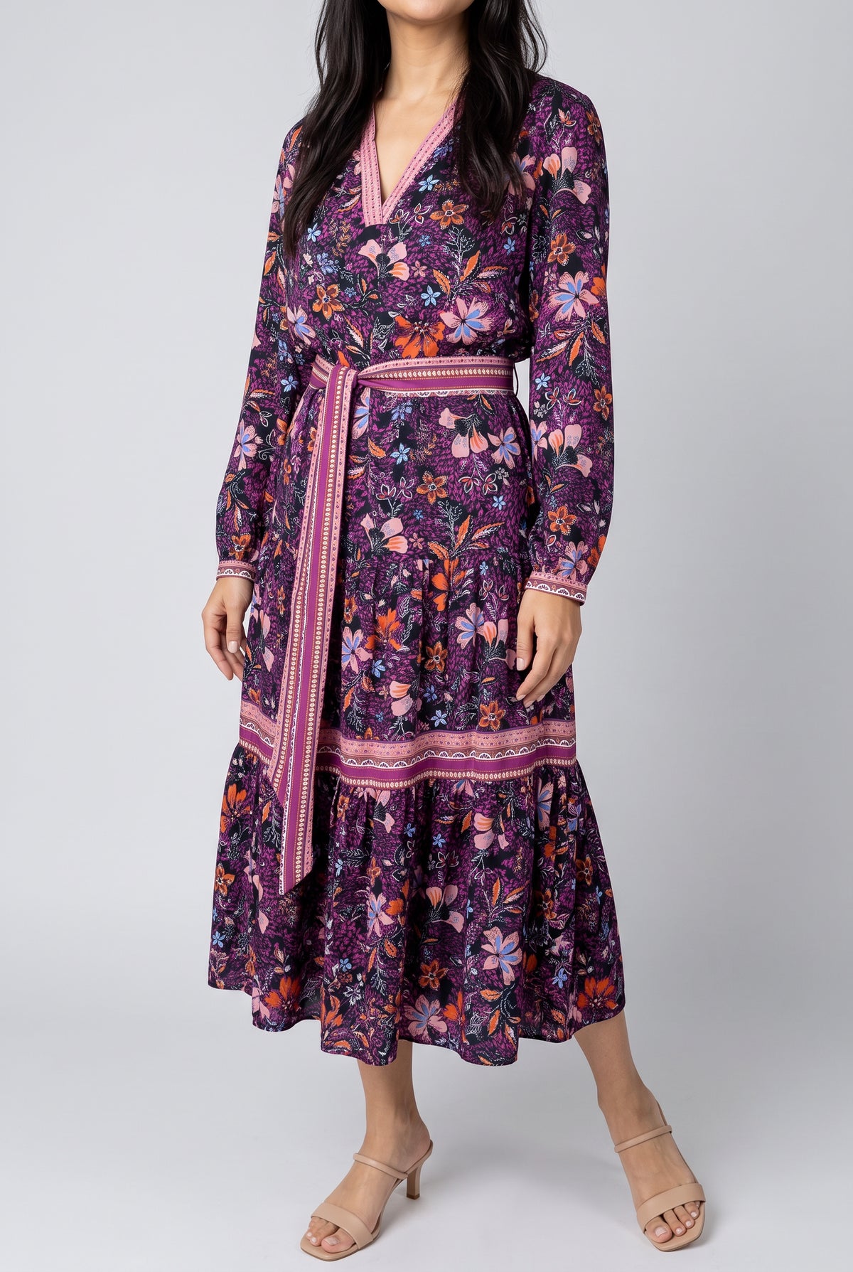 Angled side view of the Live in the Moment floral dress showing its waist, sleeve volume and skirt fall.