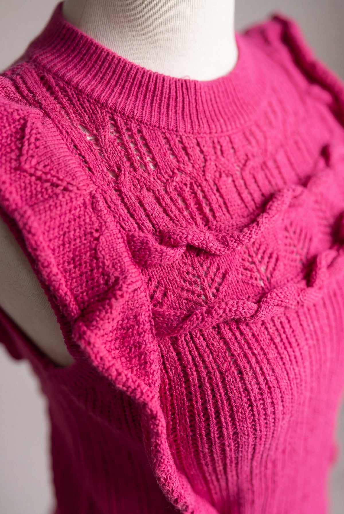 Knit detail of the Love Me Again Sweater Top showing the openwork yoke and layered ruffle attachment.