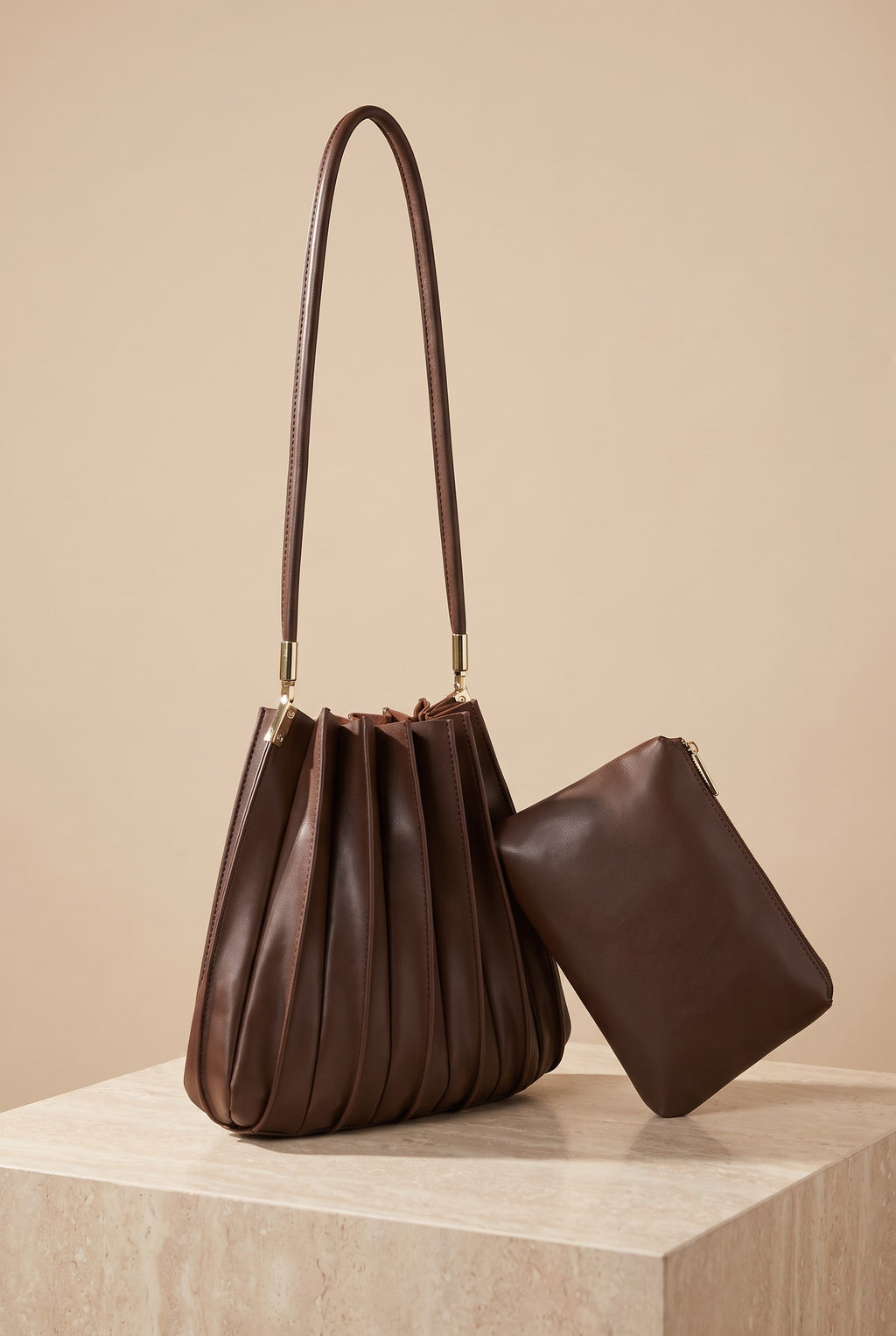 The Carrie chocolate pleated shoulder bag on its own, showing its shape.