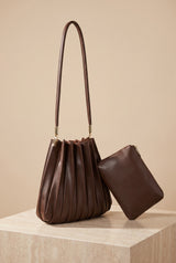 The Carrie chocolate pleated shoulder bag on its own, showing its shape.