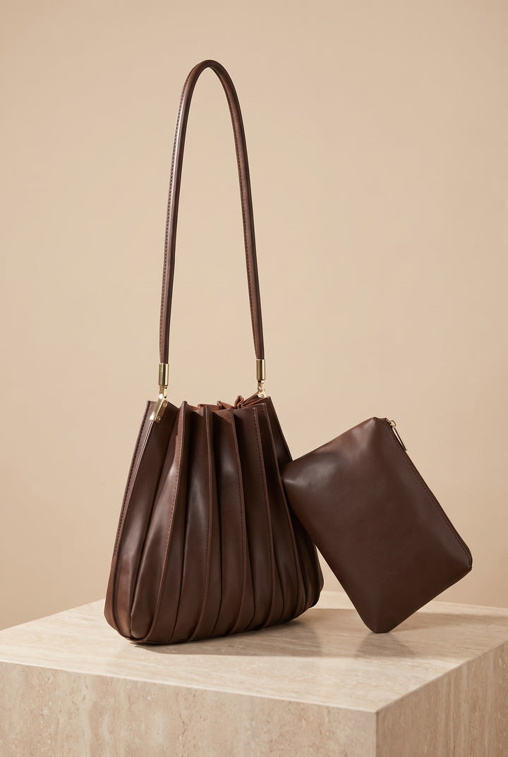 The Carrie chocolate pleated shoulder bag on its own, showing its shape.