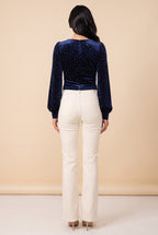 Back view of the Heart of Glass navy velvet sweetheart top worn by our model.