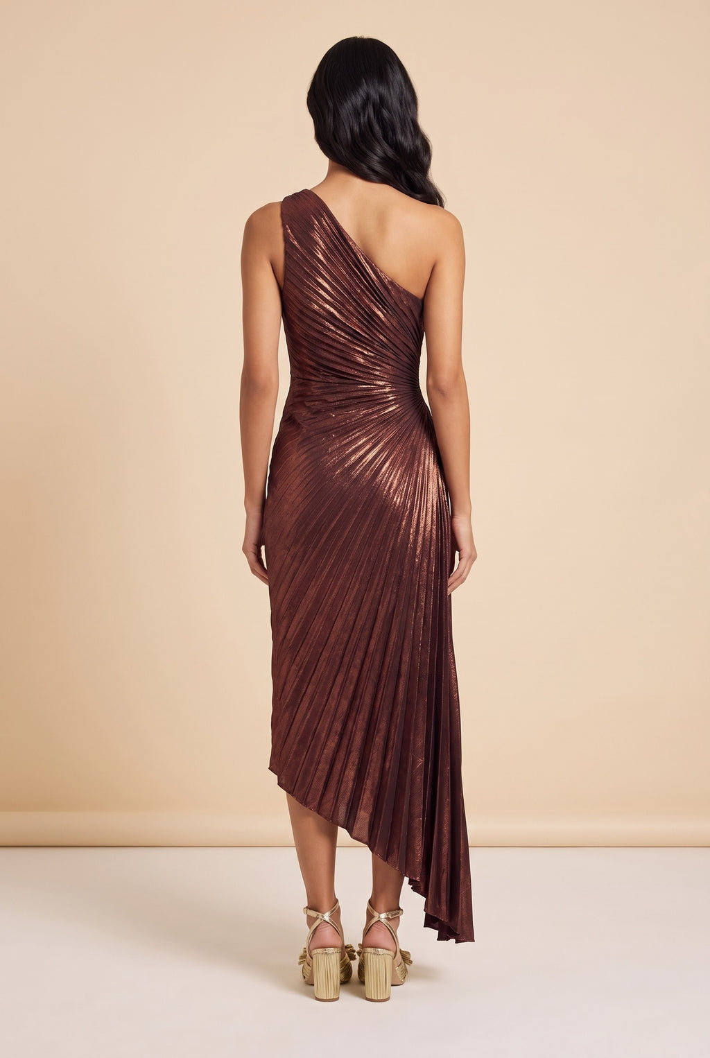 Back view of the metallic burgundy pleated one shoulder maxi dress.