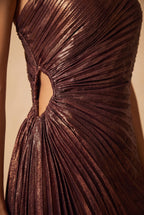 Close-up of the metallic burgundy pleated one shoulder maxi dress showing the fabric and finishing details.