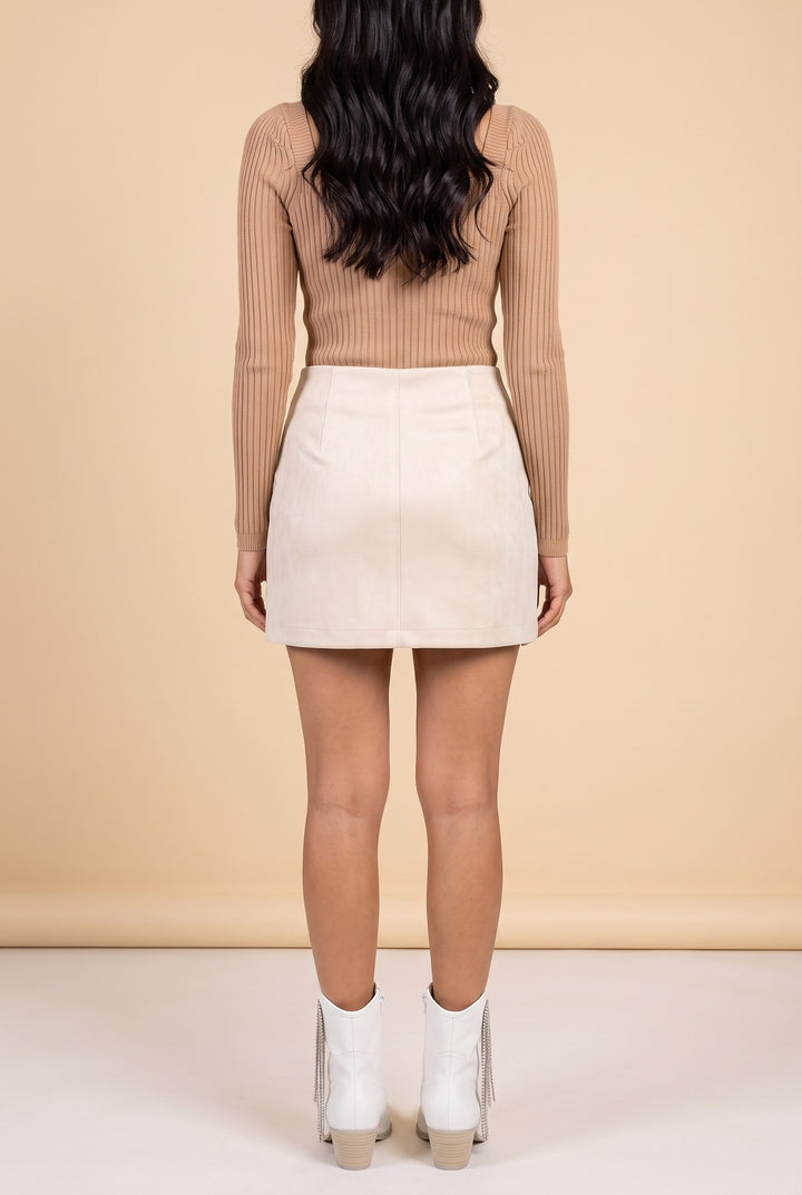 Back view of the cream embroidered faux suede mini skirt.