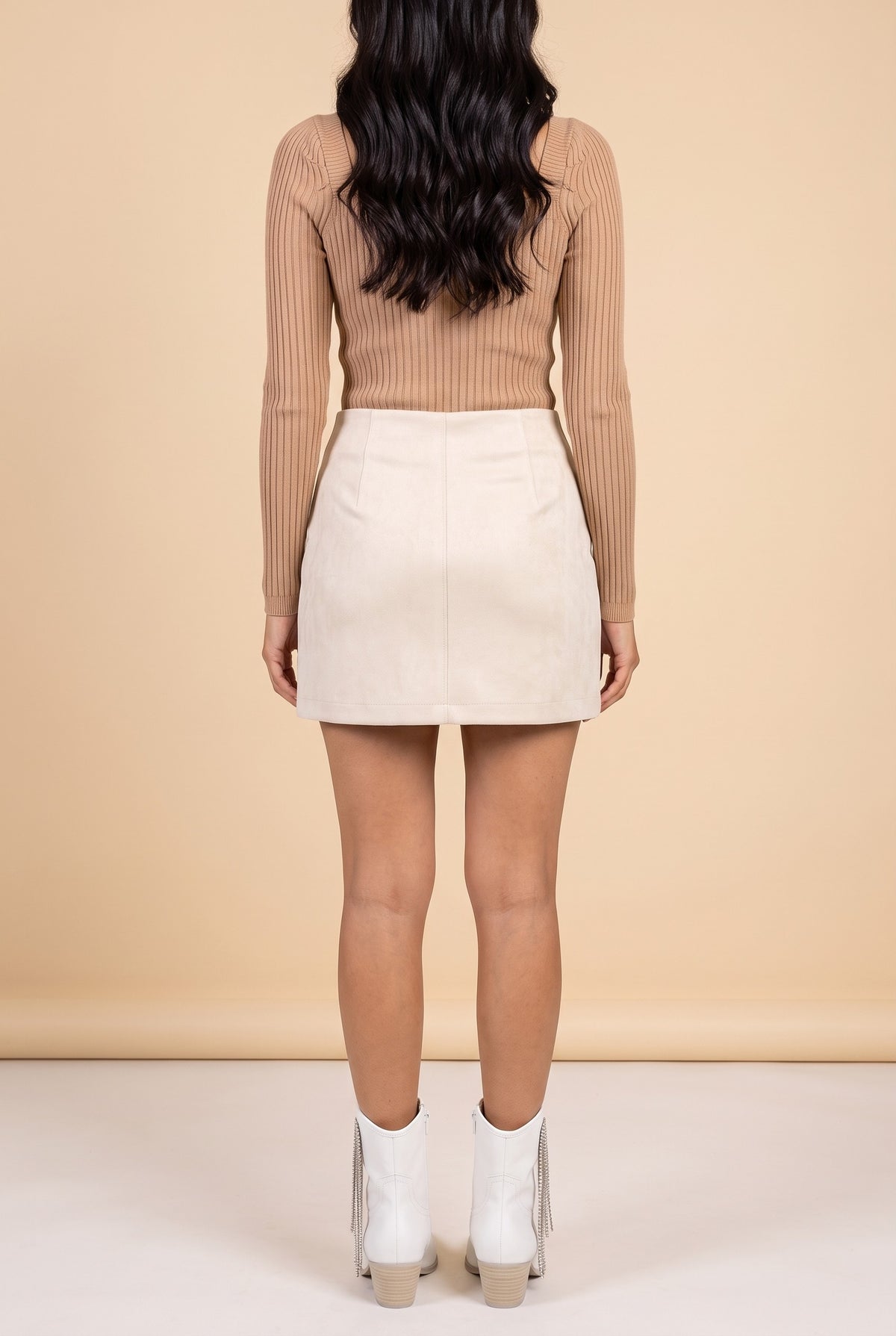 Back view of the cream embroidered faux suede mini skirt.