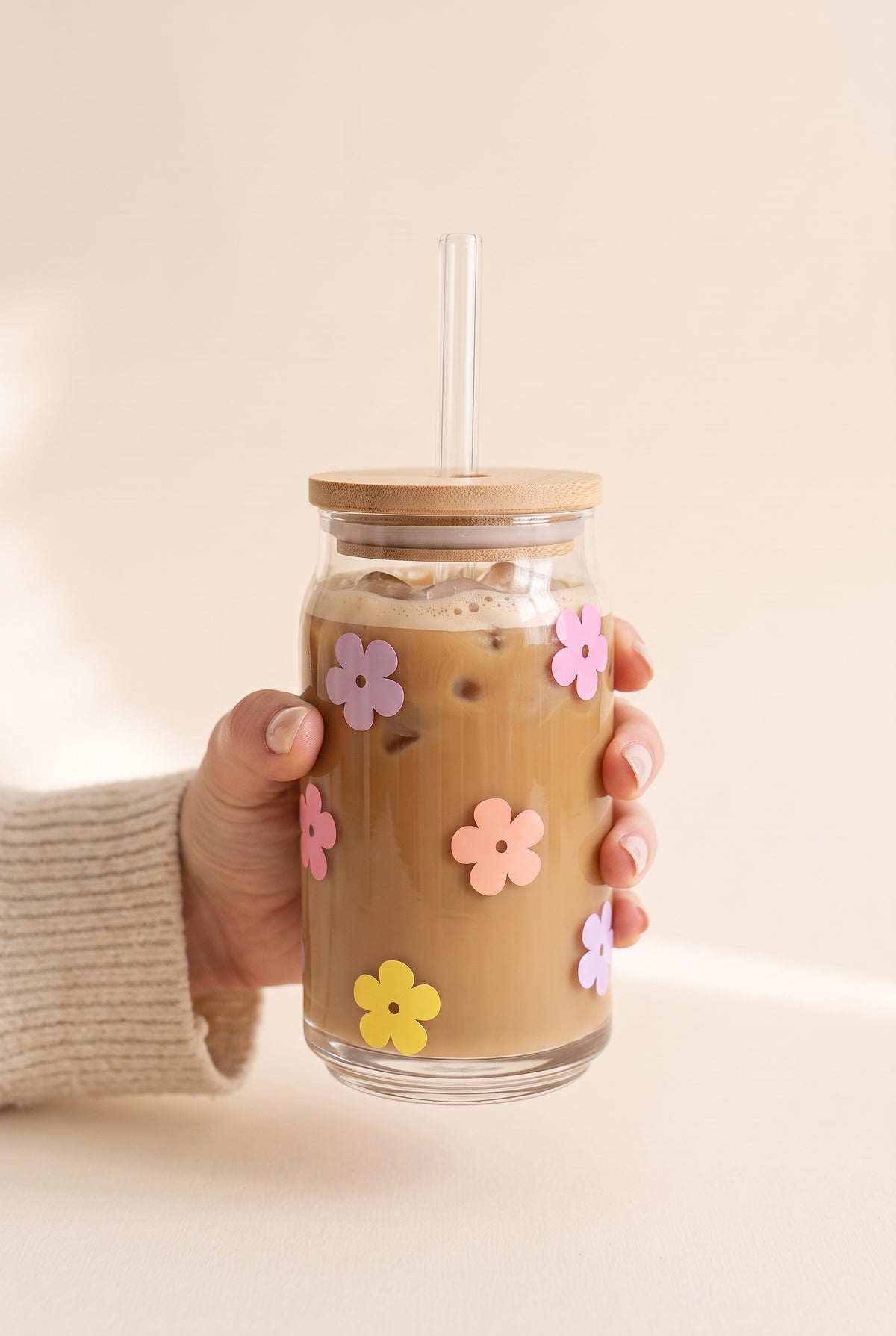 Josie Daisy Glass Cup held in one hand, showing the true size of the 16 oz can glass with bamboo lid and glass straw