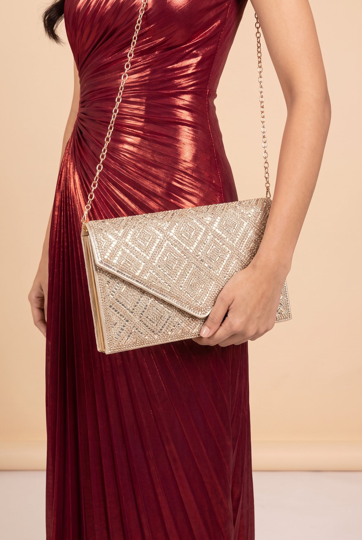 The Gemma rhinestone envelope clutch carried at the hip.