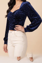 Side view of the Heart of Glass navy velvet sweetheart top worn by our model.