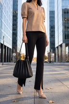 The latte faux leather top styled with black slit-front flare trousers, nude bow slingback pumps and a black pleated shoulder bag for the office.