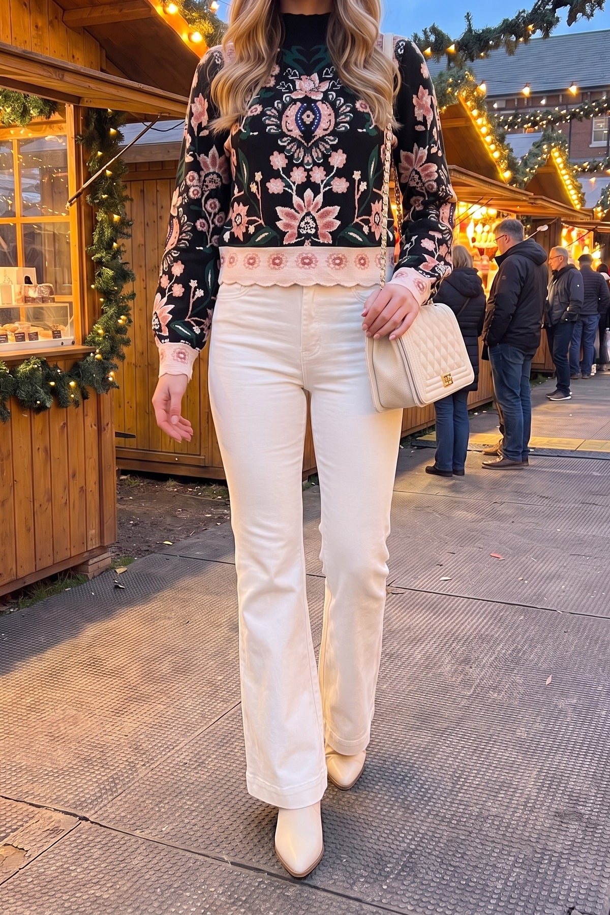 The floral jacquard sweater styled with cream high-rise flare jeans, cream western booties and a cream quilted chain bag for a winter-white holiday look.
