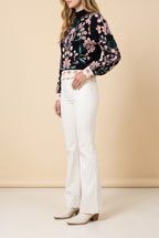 Side view of the black floral jacquard high neck sweater showing the silhouette.