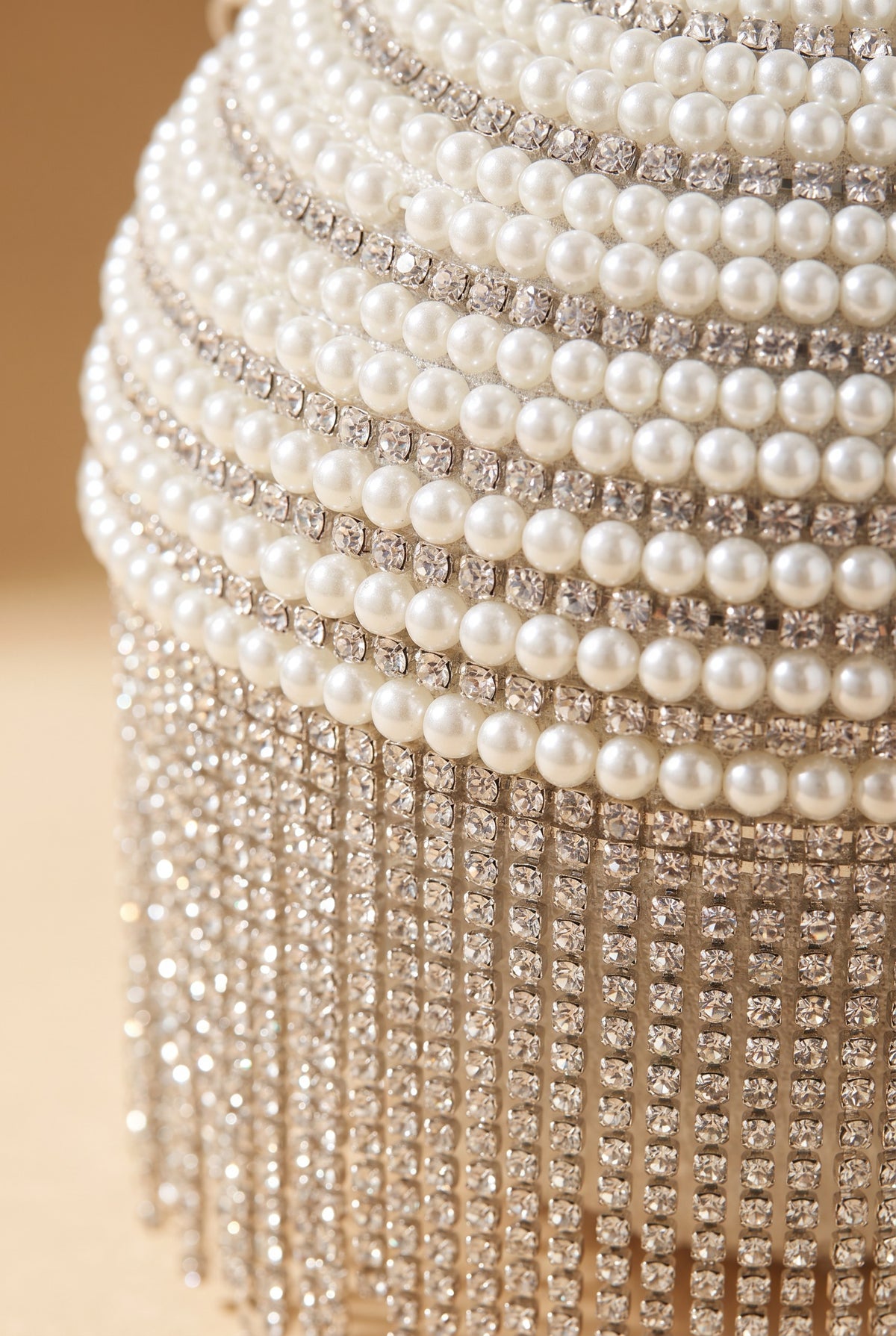 Close view of the Lola pearl rhinestone fringe ball bag showing the material and details.