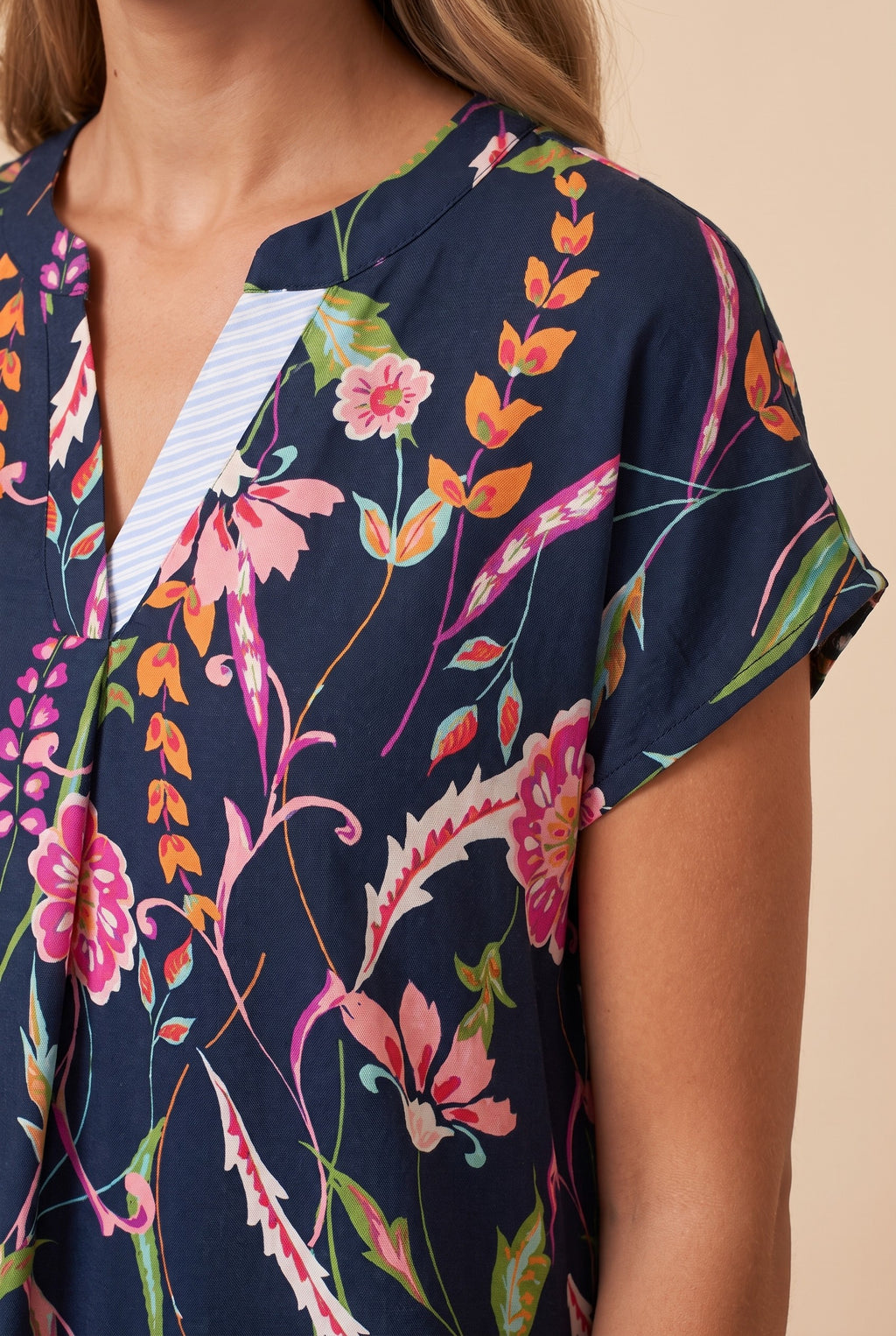 Close-up of the navy floral short sleeve shift dress showing the fabric and details.
