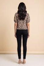 Back view of the taupe leopard puff sleeve top.