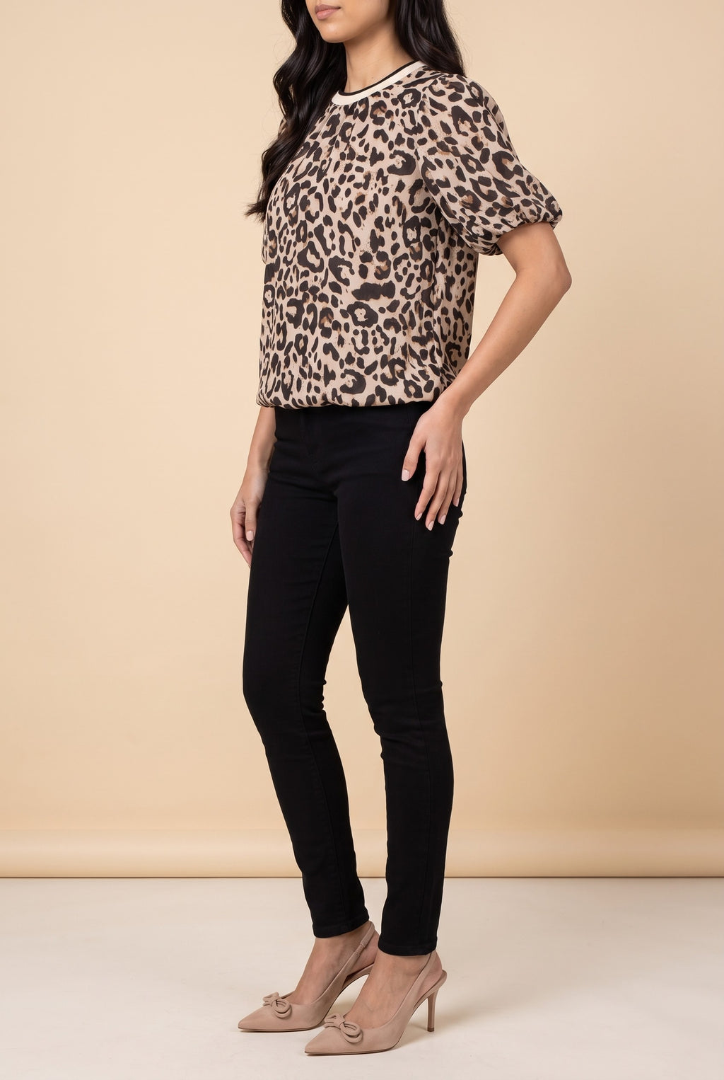 Side view of the taupe leopard puff sleeve top showing the silhouette.