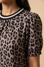 Close-up of the taupe leopard puff sleeve top showing the fabric and details.