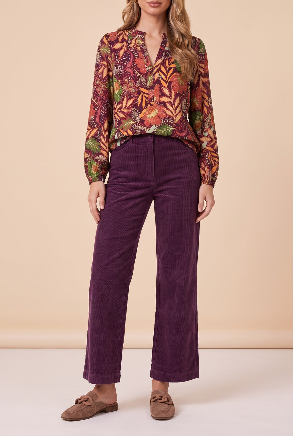 Front view of the burgundy floral split neck blouse showing the fit and length.