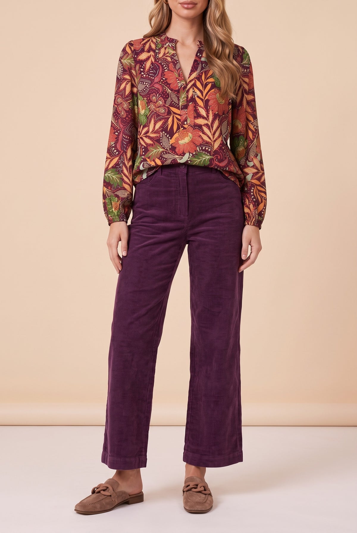 Front view of the burgundy floral split neck blouse showing the fit and length.