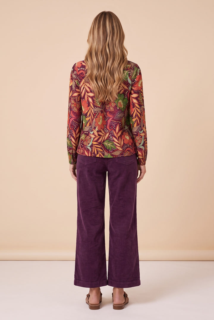 Back view of the burgundy floral split neck blouse.