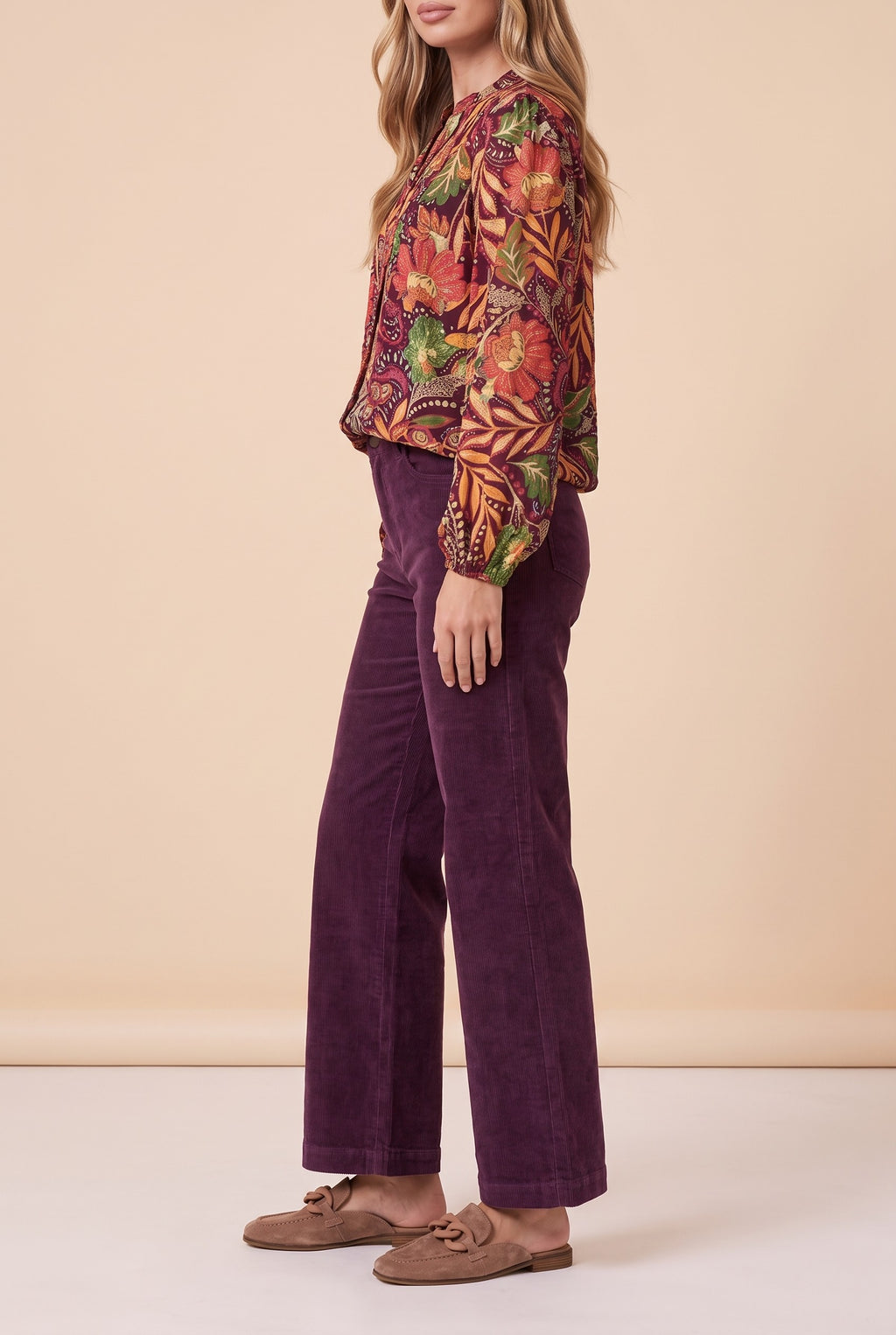 Side view of the burgundy floral split neck blouse showing the silhouette.