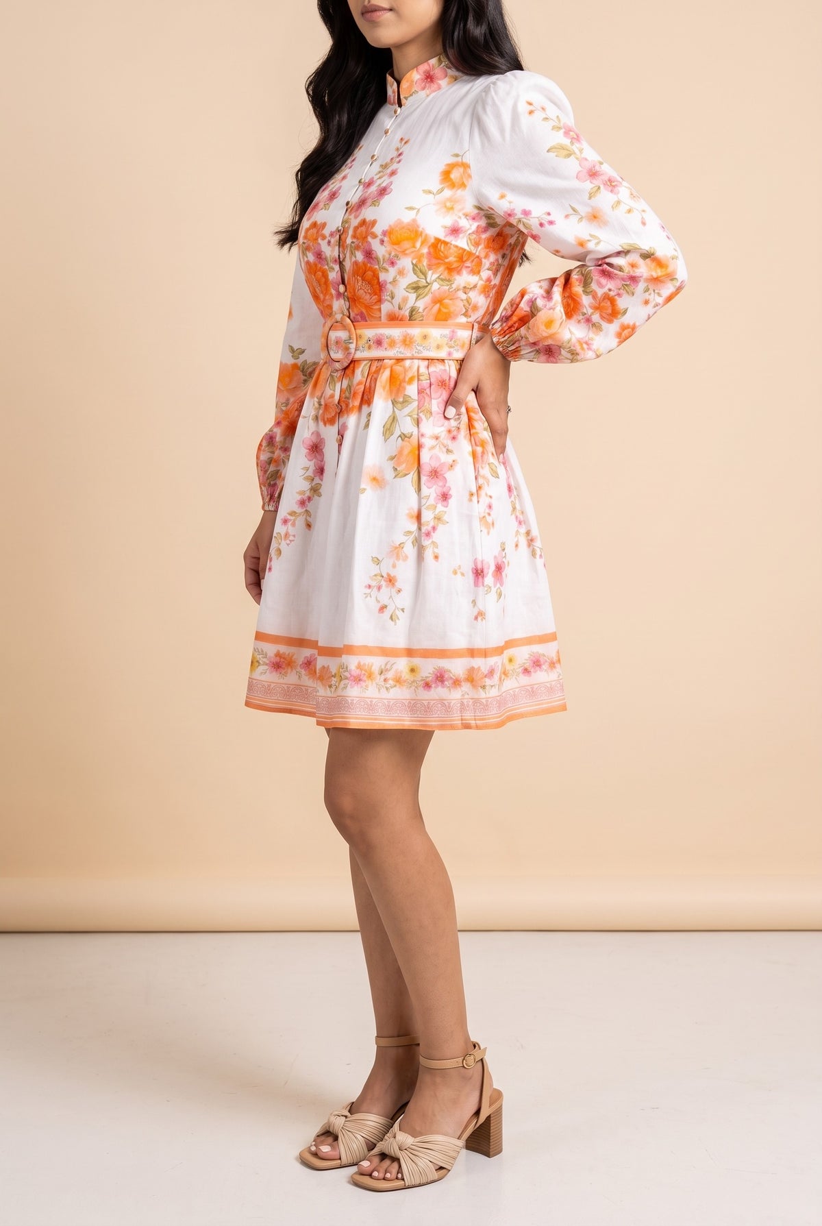 Side view of the Sweet Sunshine mock neck floral border mini dress showing the silhouette.