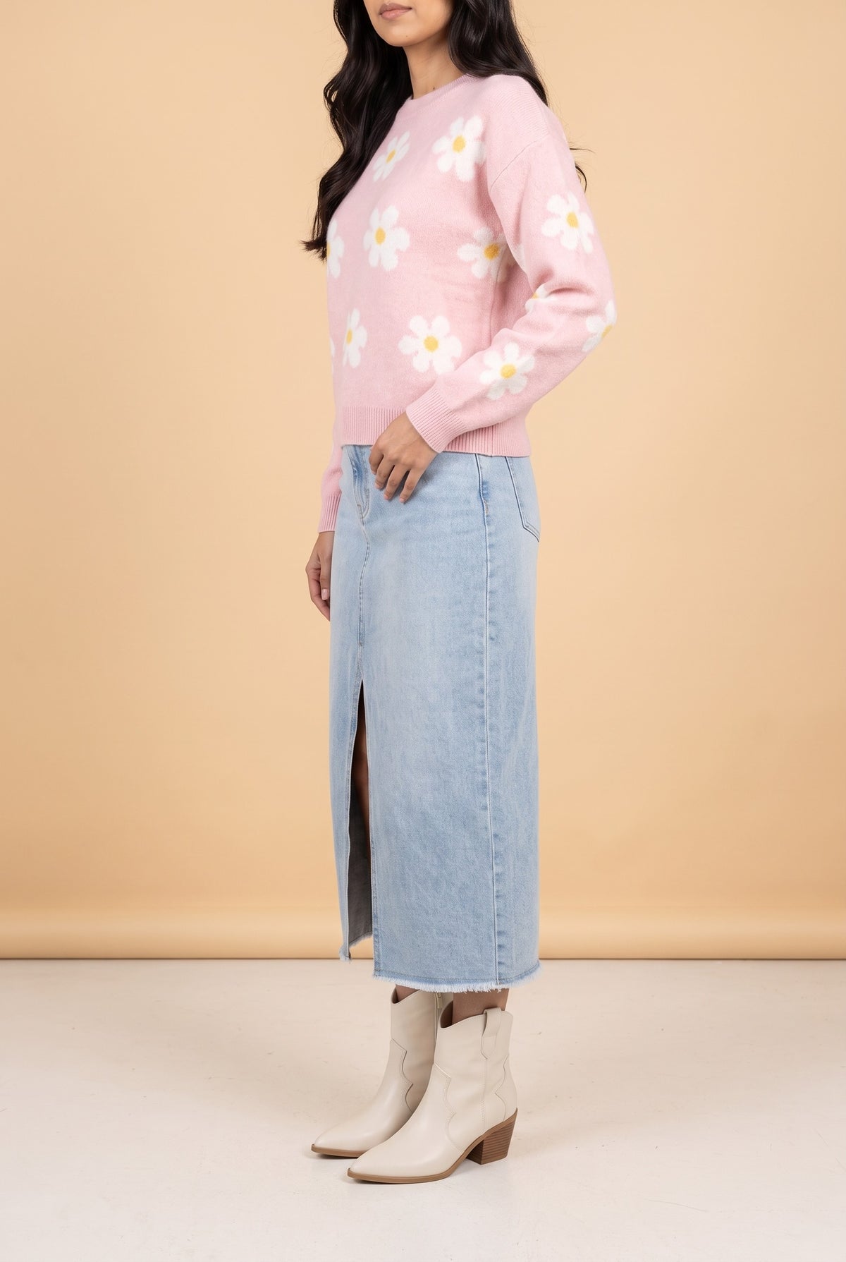 Side view of the Let's Just Stay pink daisy floral sweater showing the silhouette.