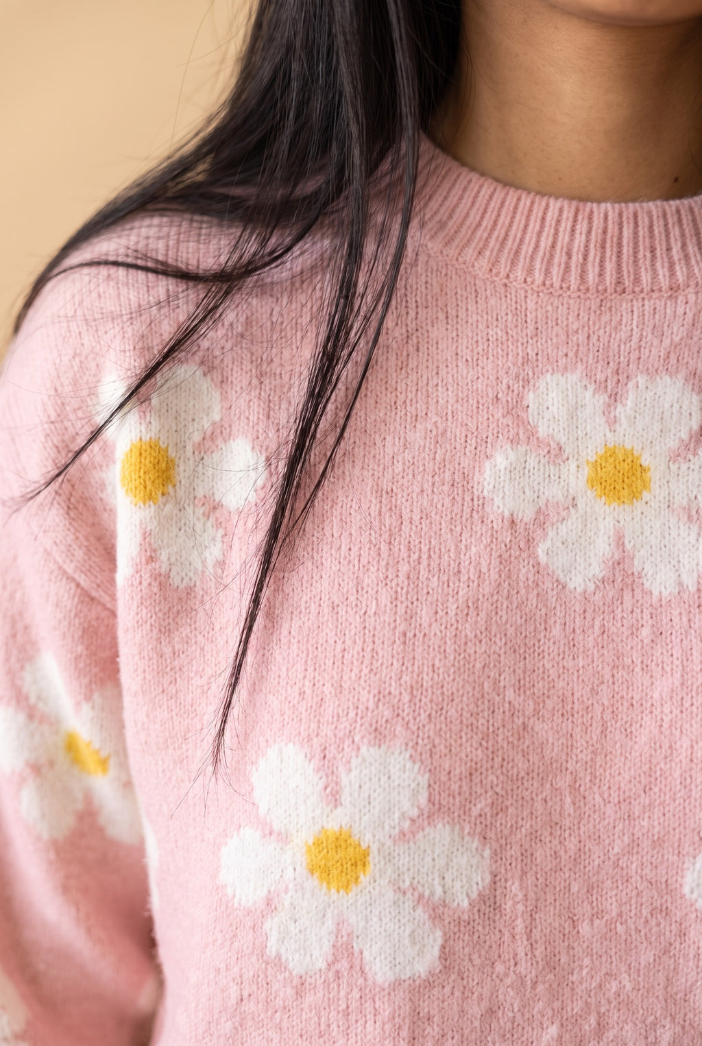 Close-up of the Let's Just Stay pink daisy floral sweater showing the fabric and details.