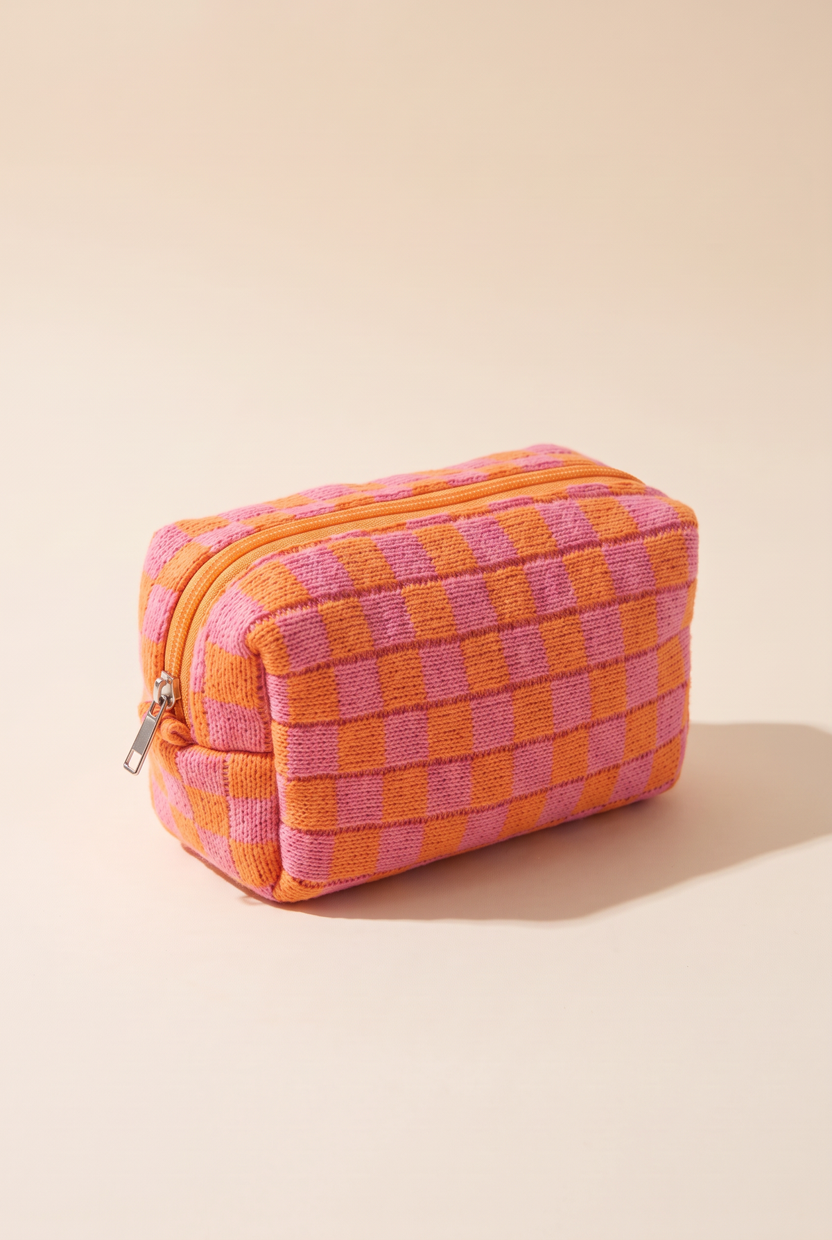 Check Yourself Cosmetic Bag in Orange, boxy knit pouch in orange and pink checks with an orange zip and silver metal pull