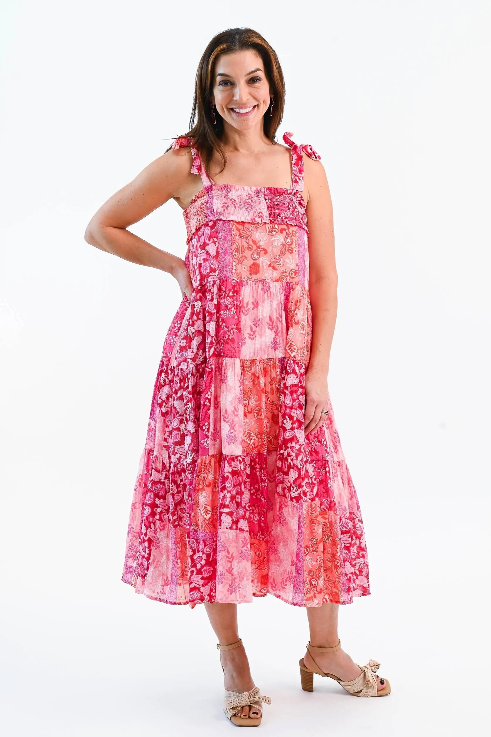 Boho Patchwork Tiered Midi Dress in pink and red with adjustable tie straps and a flowy tiered skirt. Perfect for summer outings.