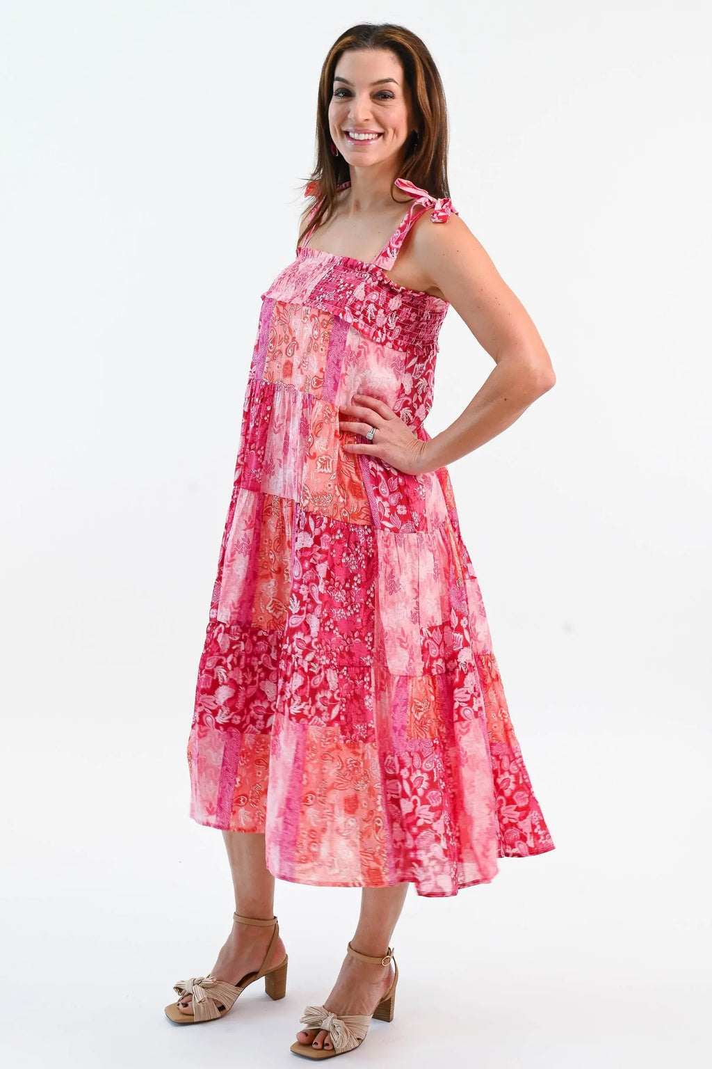 Boho Patchwork Tiered Midi Dress in pink and red with adjustable tie straps and a flowy tiered skirt. Perfect for summer outings.