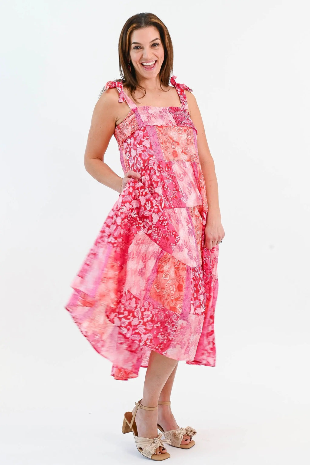 Boho Patchwork Tiered Midi Dress in pink and red with adjustable tie straps and a flowy tiered skirt. Perfect for summer outings.