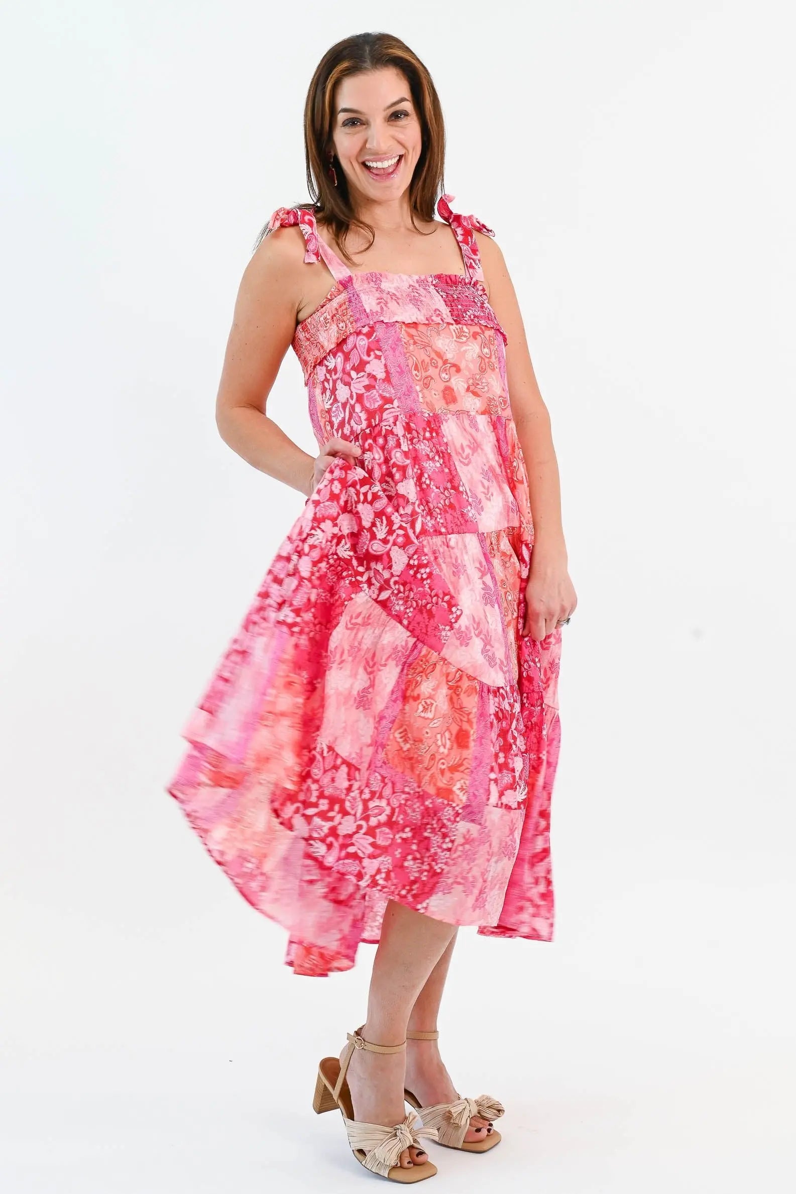 Boho Patchwork Tiered Midi Dress in pink and red with adjustable tie straps and a flowy tiered skirt. Perfect for summer outings.