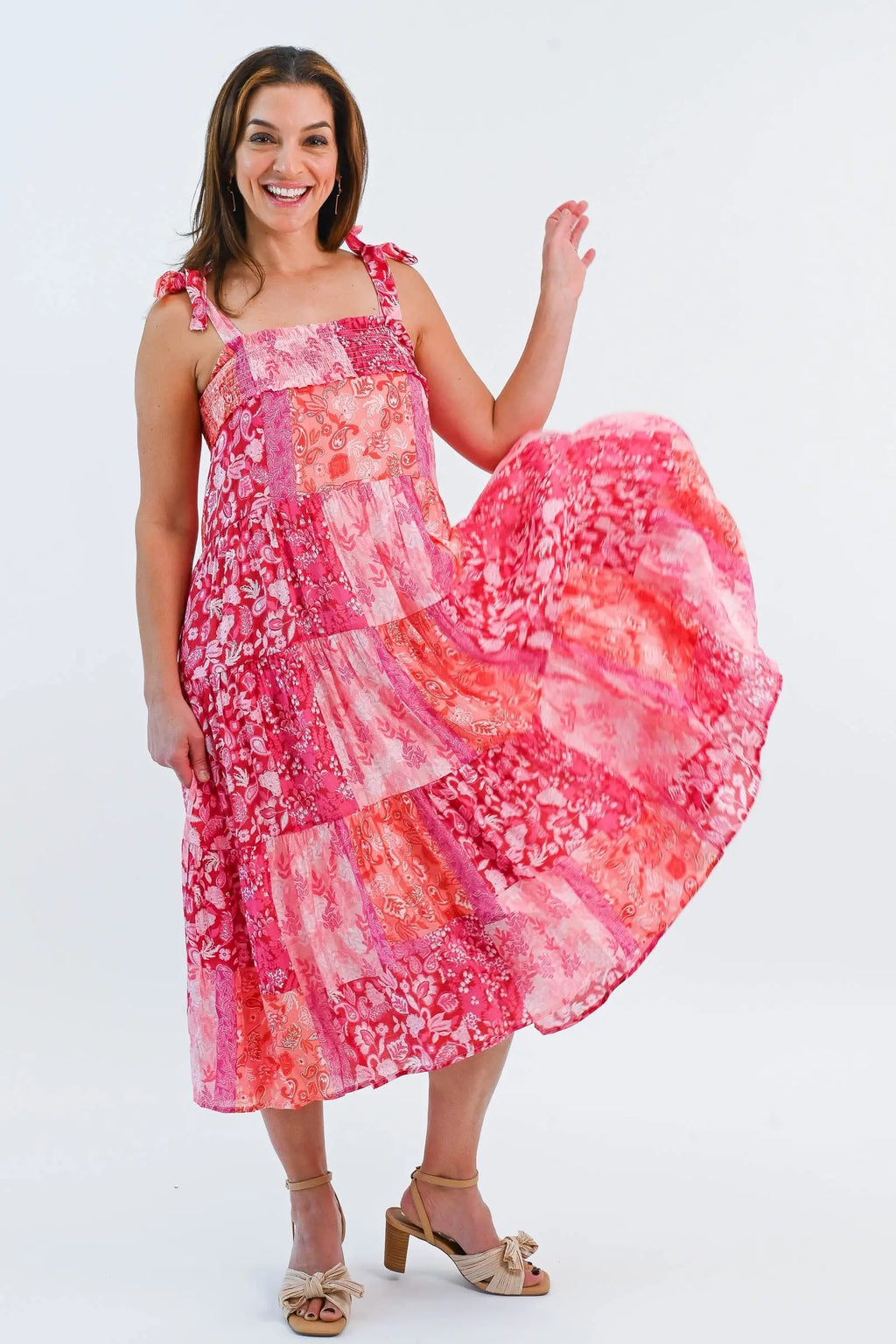 Boho Patchwork Tiered Midi Dress in pink and red with adjustable tie straps and a flowy tiered skirt. Perfect for summer outings.