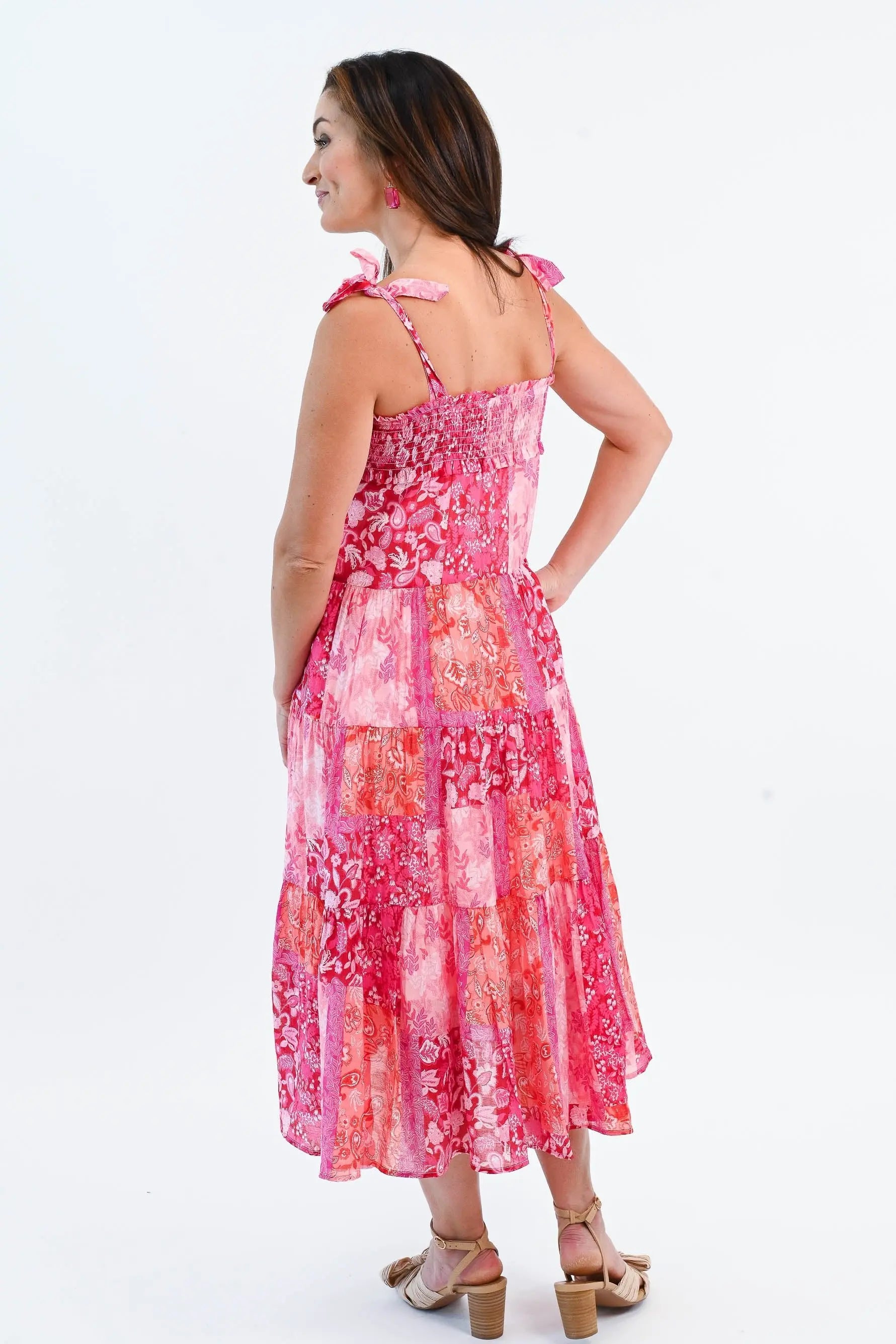 Boho Patchwork Tiered Midi Dress in pink and red with adjustable tie straps and a flowy tiered skirt. Perfect for summer outings.