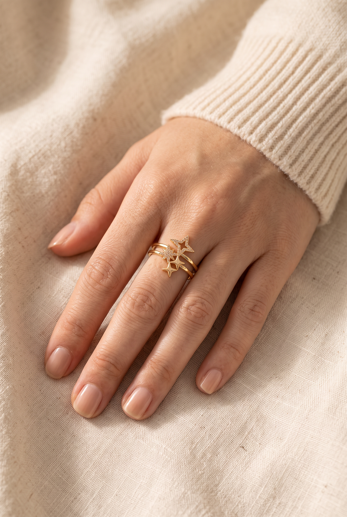 Gemma Gold Plated Constellation Ring worn on one finger at true size: a small cluster of four stars on an open double band