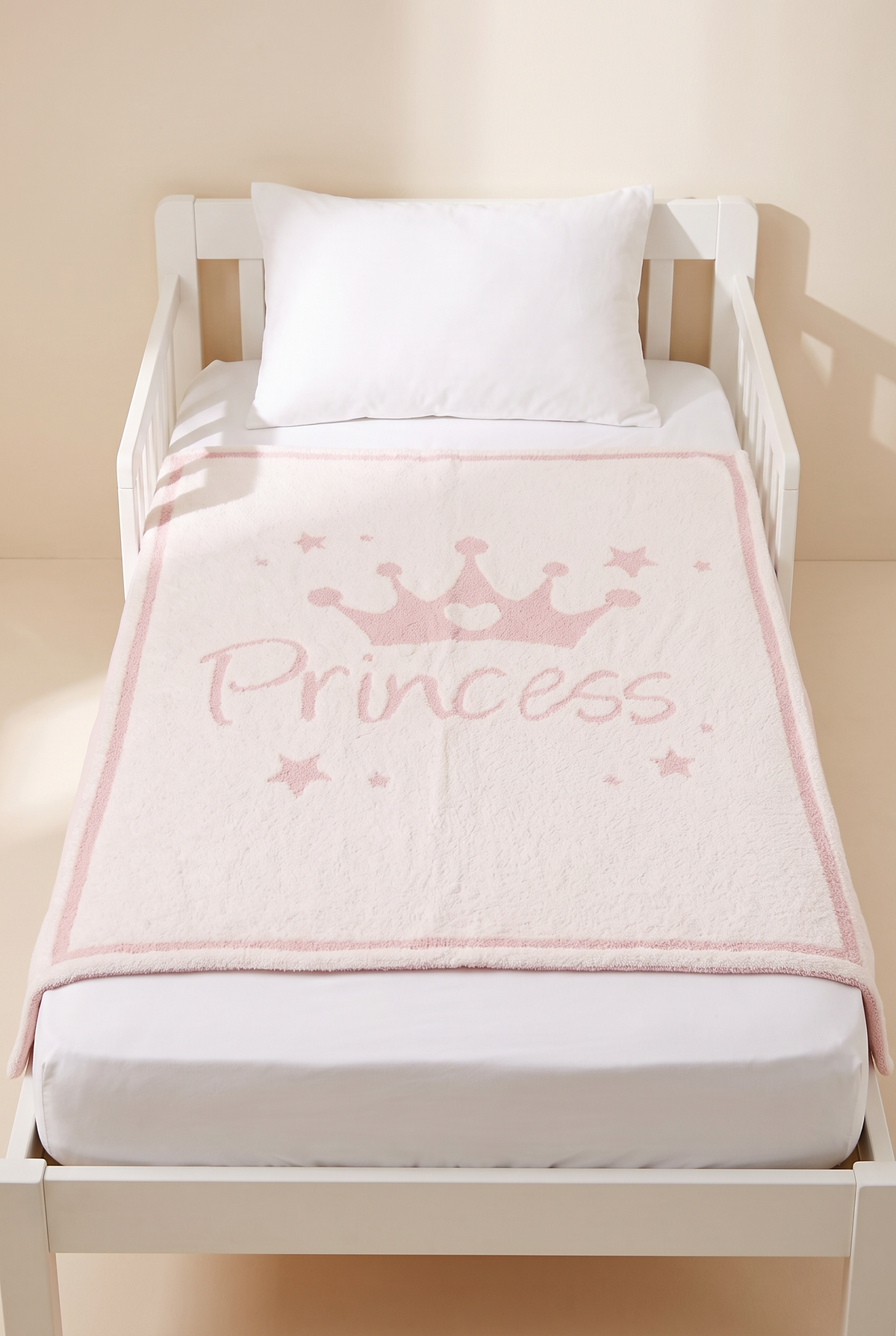 Molly Princess kids throw laid flat on a toddler bed, showing its true 29 x 35 inch size
