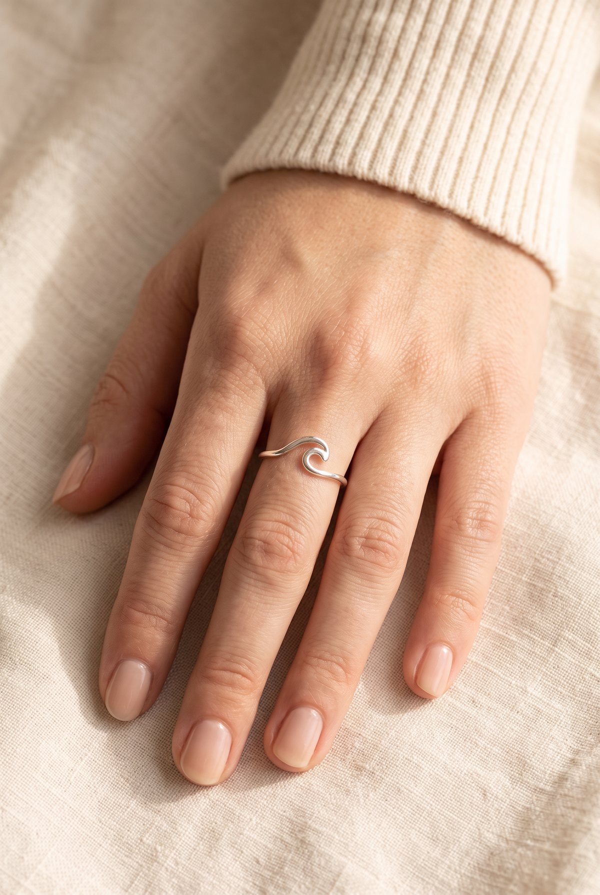 Fiona Wave Cutout Adjustable Ring worn on one finger at true size: a slim silver band with a small wave at the front