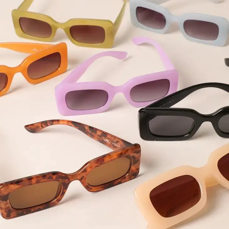 Model wearing retro square frame sunglasses with a modern bold design.