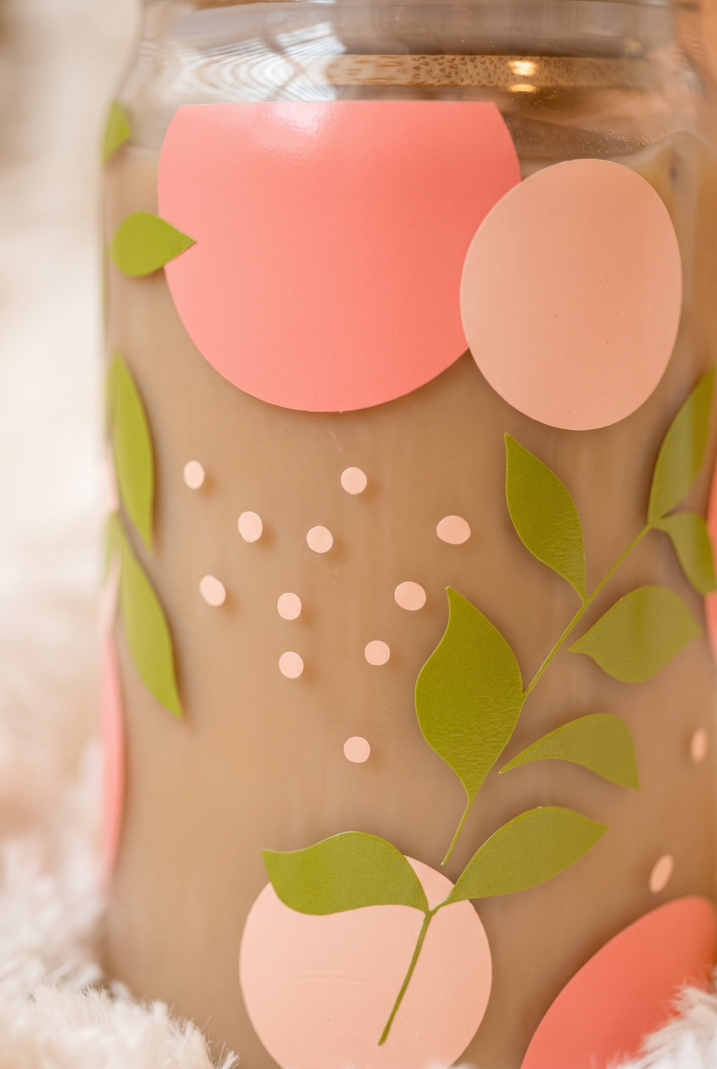 Close-up of the peach, leaf and dot print on the Adeline glass cup
