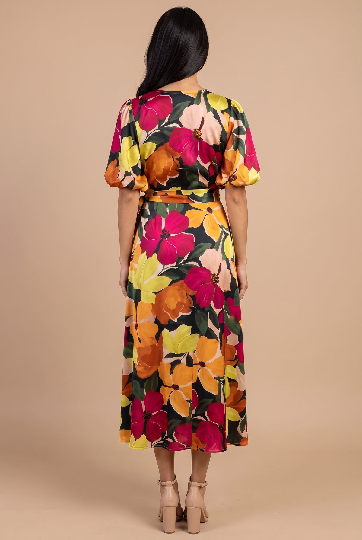 Back view of the If You're Not the One floral wrap midi dress, showing the plain back, bubble sleeves and skirt length.