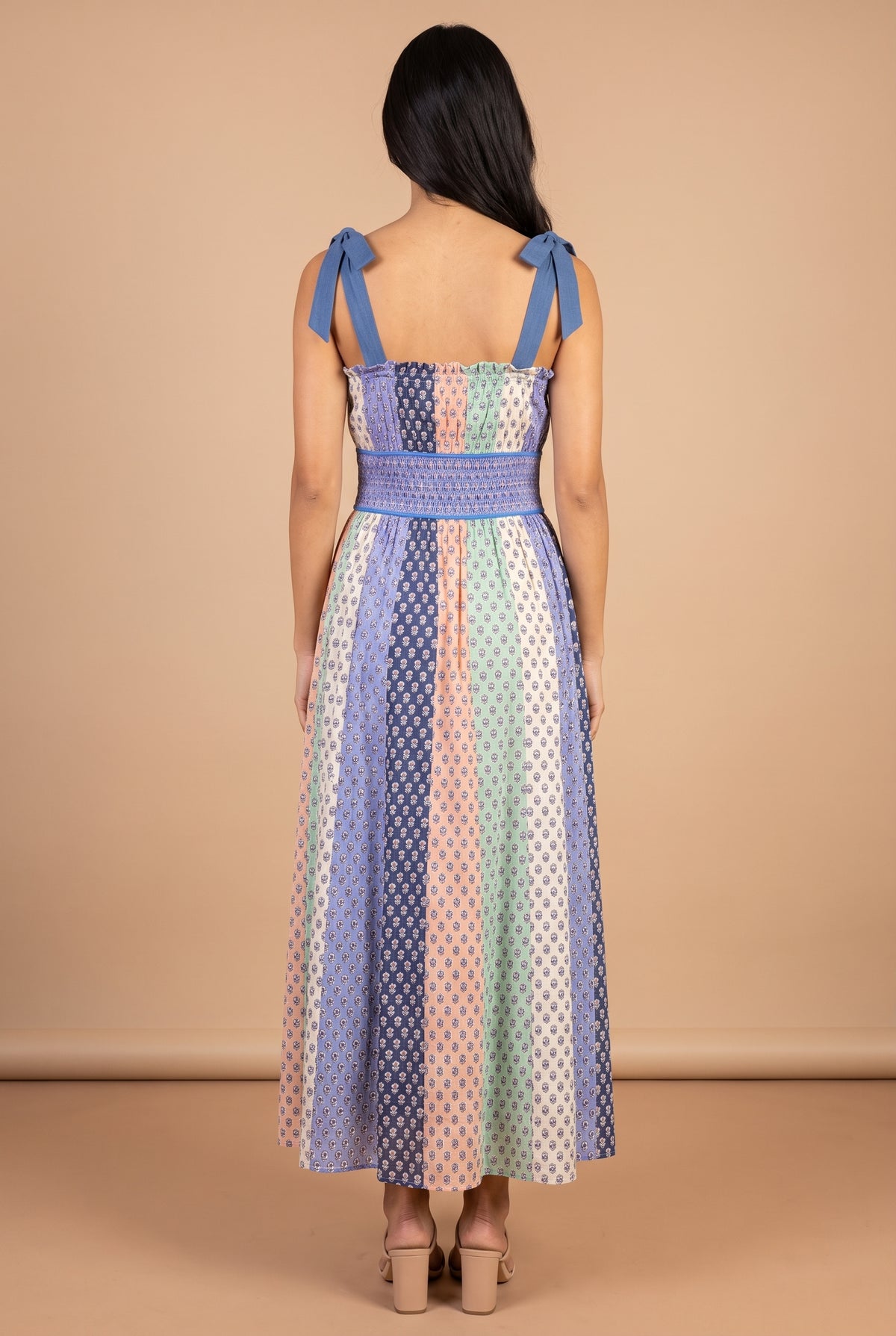 Back view of the Feeling The Sunshine maxi dress, showing the tie bows on the shoulders and the shirred waist panel.
